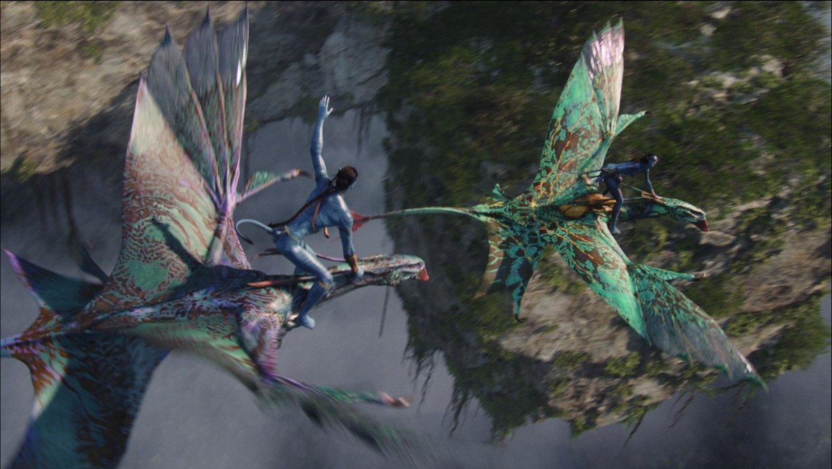 Two Na'vi fly on colorful animals in Avatar
