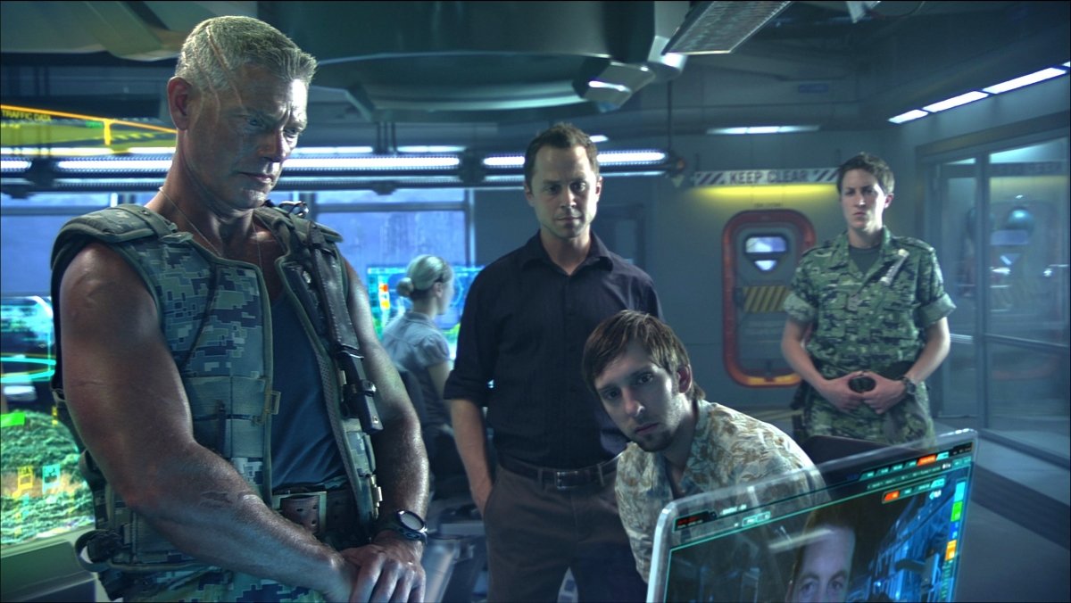 The colonel, head of the RDA, and Norm in the control room in Avatar