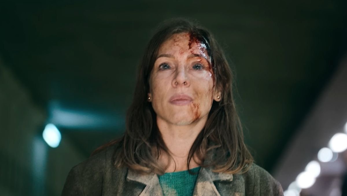 Bird Box Barcelona photo of a woman standing on a train rail with blood on her forehead