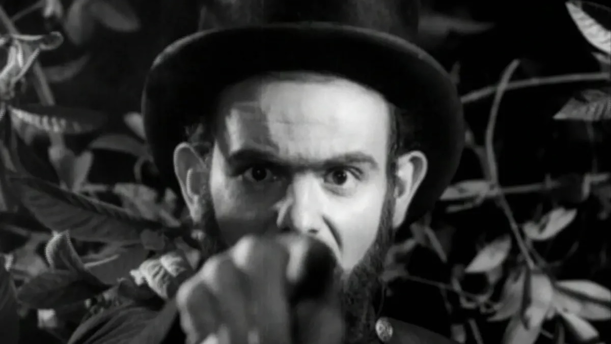 Coffin Joe (Jose Mojica Marins) points at the camera in the 1964 Brazilian horror movie At Midnight I'll Take Your Soul.