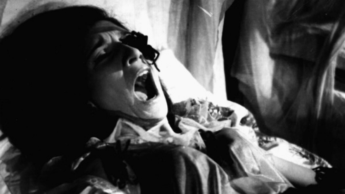 A woman screams as tarantulas crawl on her face in the Brazilian horror movie This Night I'll Possess Your Corpse.