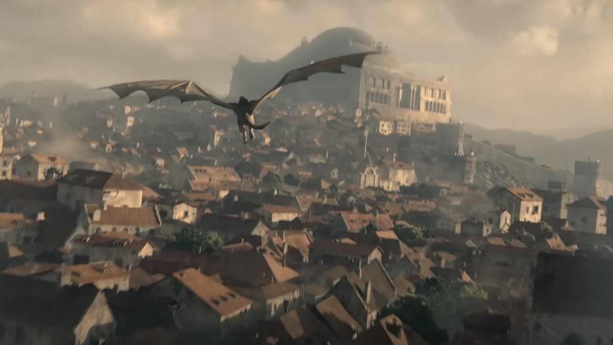 A dragon flies over King's Landing with the Dragonpit nearby on House of the Dragon
