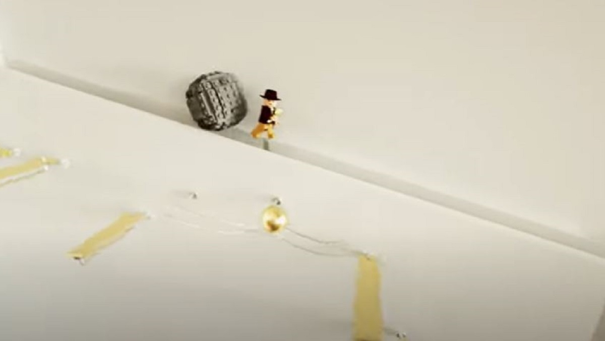 An animated LEGO Indiana Jones runs from a boulder in this virtual marble run.