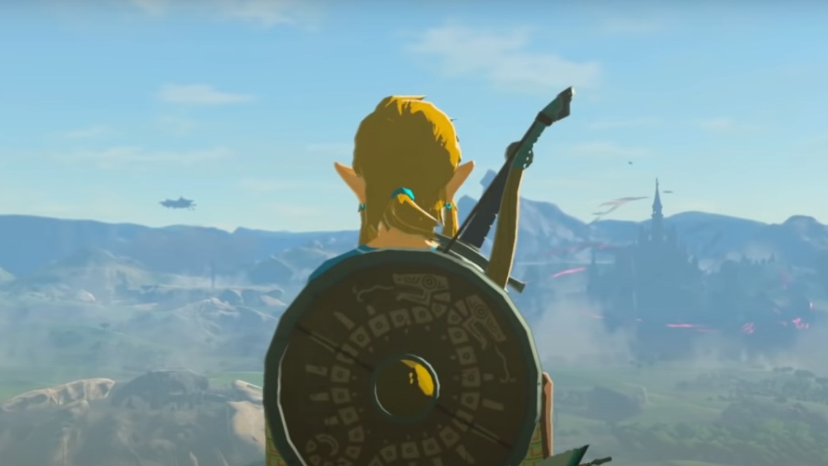 a photo of Link from Legend of Zelda facing an open, hilly terrain with his shield and weapon on him