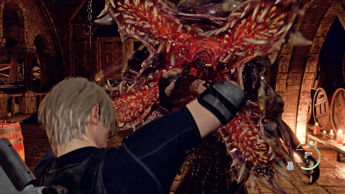 Leon Kennedy stabs a monster in the mouth in Resident Evil 4 remake.