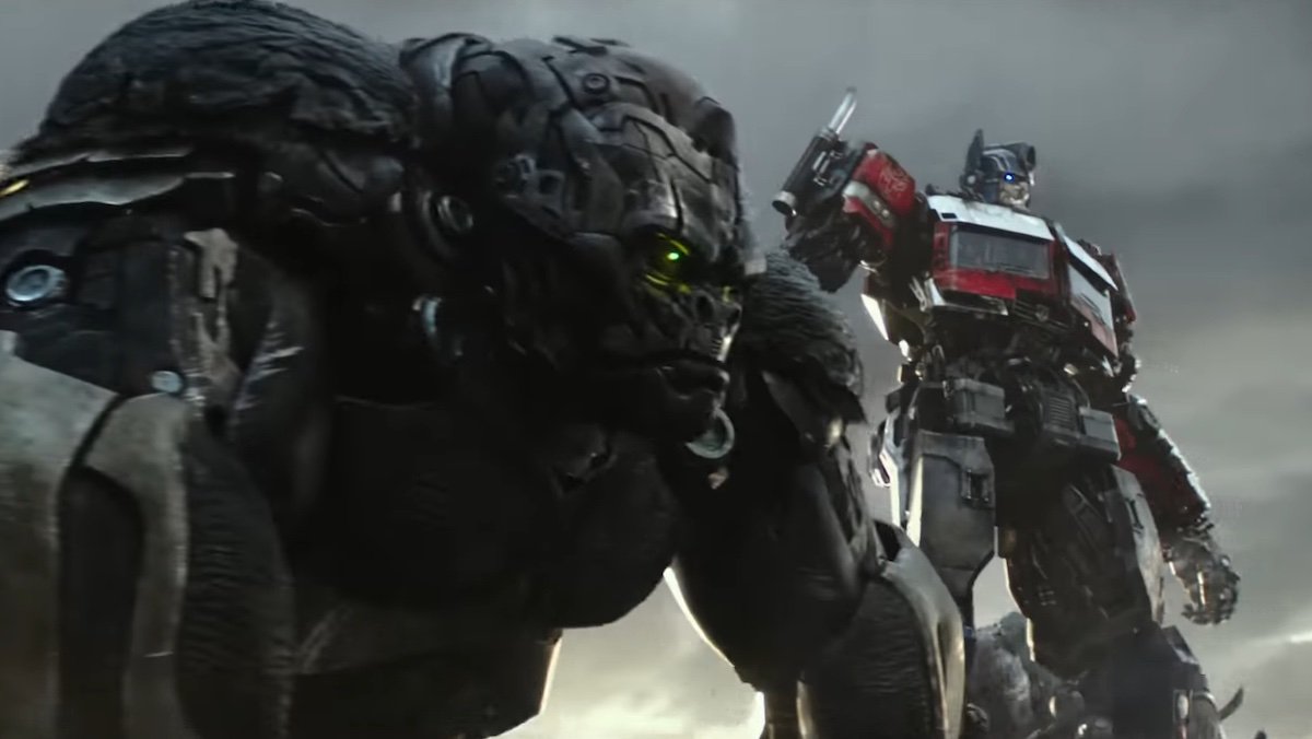 The giant gorilla robot Optimus Primal stands in front of Optimus Prime