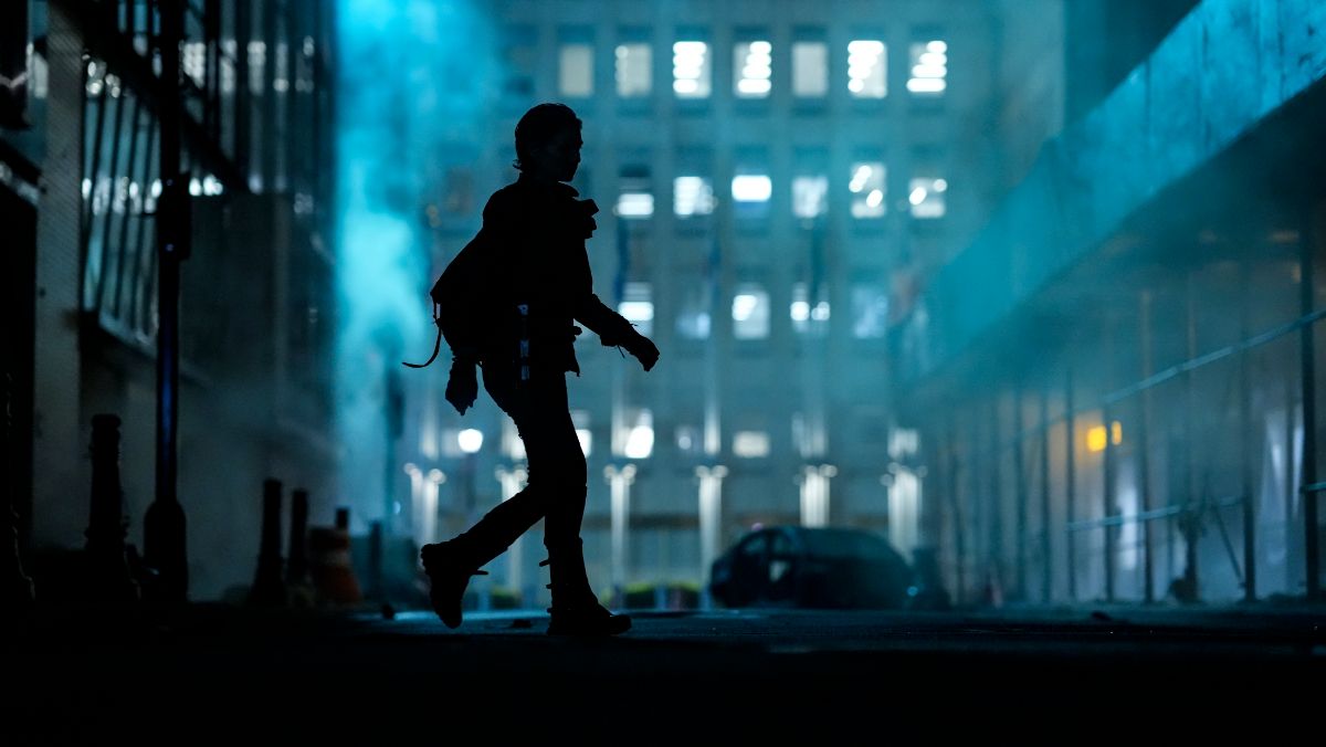 a shadow of Maggie Rhee walking across new york city street the walking dead dead city